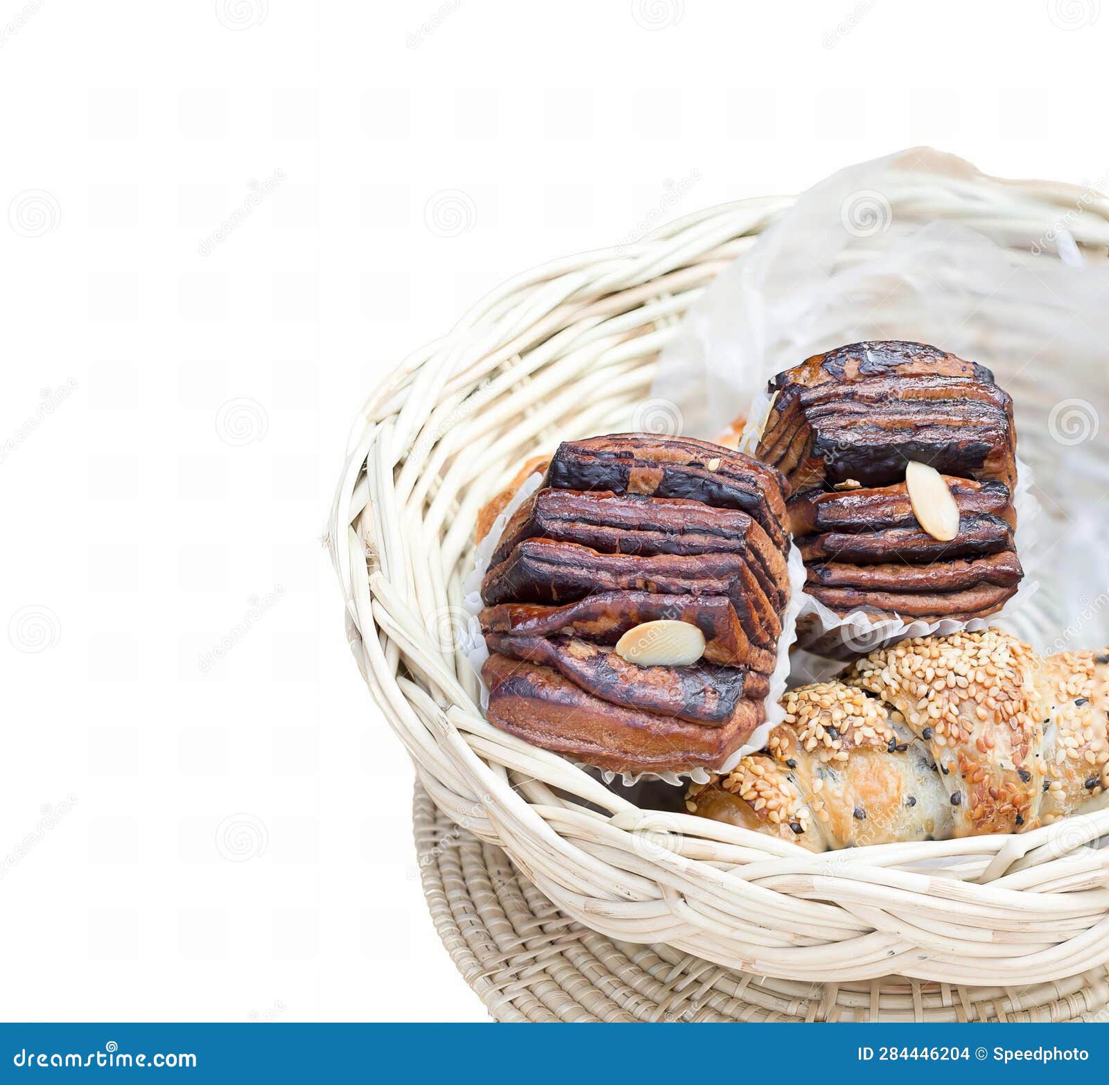 A Basket Filled With Pastries Sitting On Top Of A Table