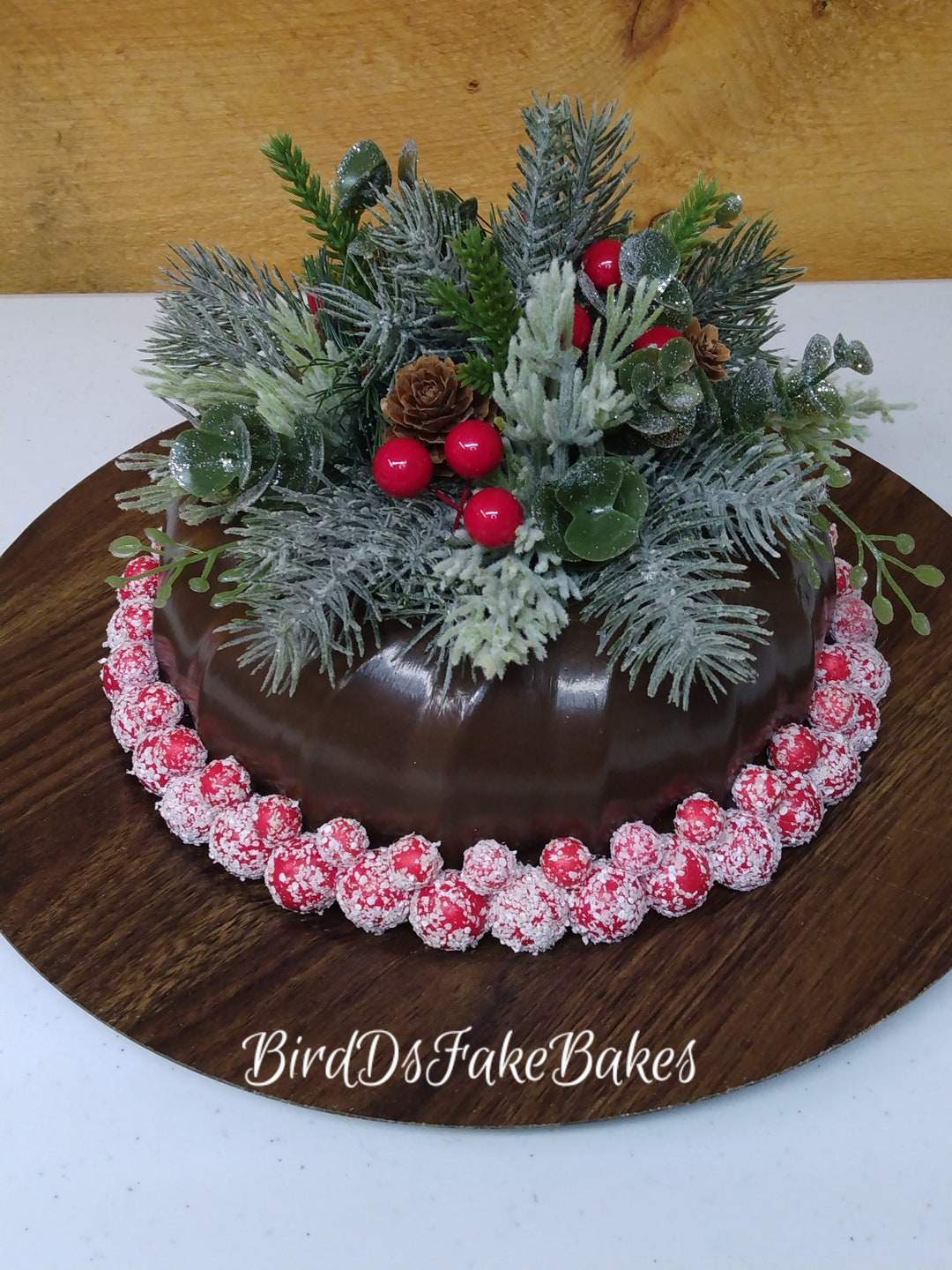 A Bundt Cake On A Plate With Pine Cones