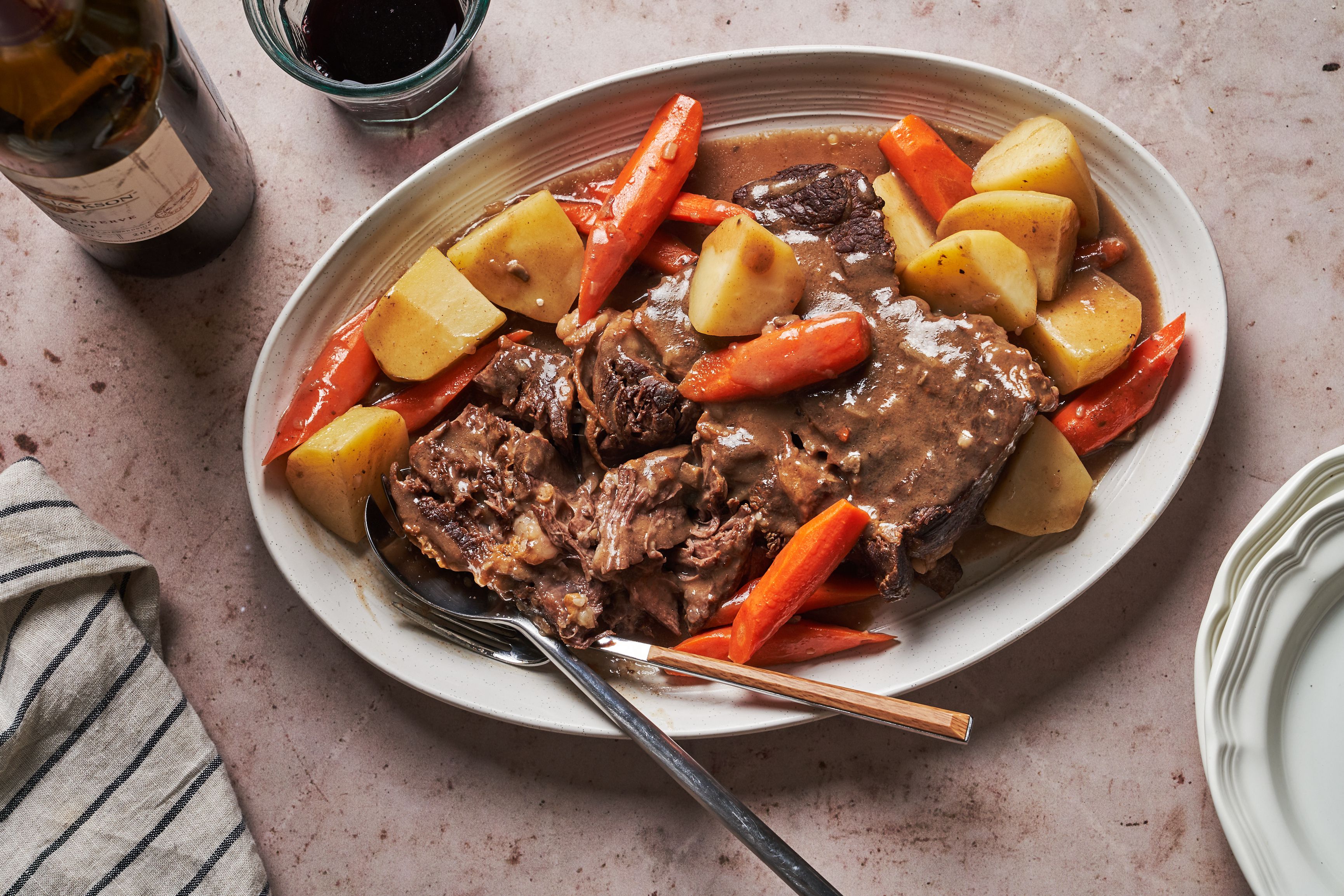 A Pot Filled With Meat And Vegetables On Top Of A Stove