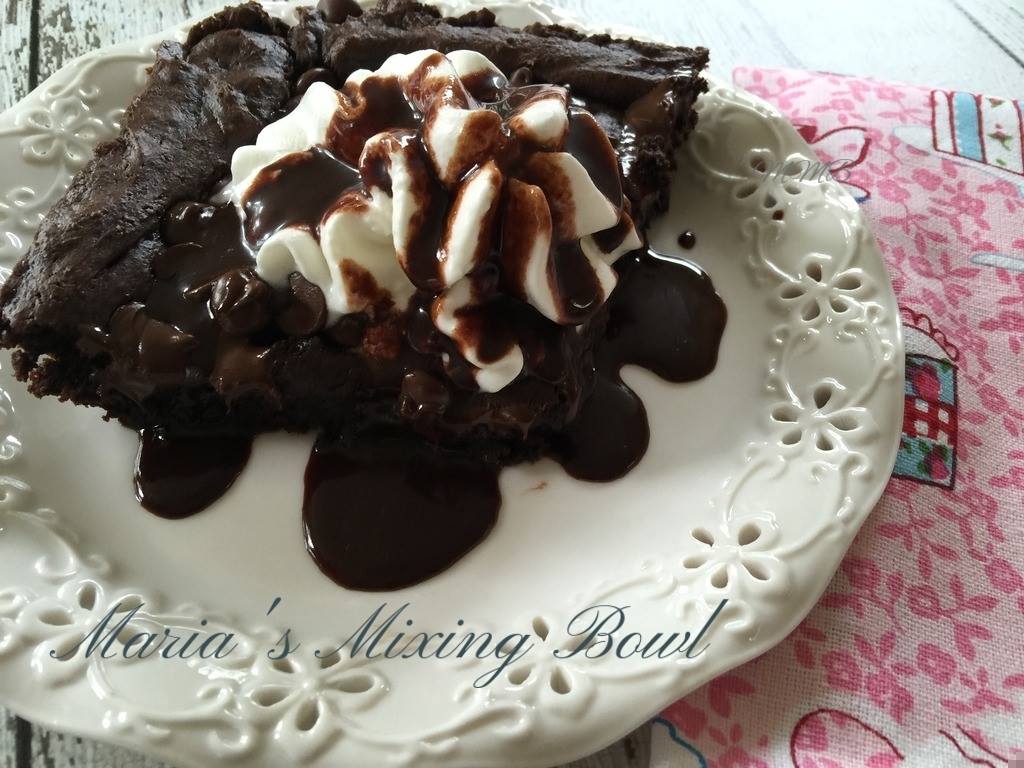 Chocolate Dump Cake In A White Bowl With A Wooden Spoon And Text Overlay That Reads Chocolate