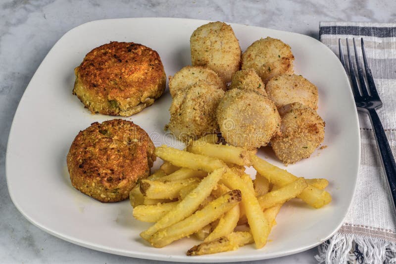 Crab Cakes With Scallops And A Side Of French Fries Stock Image Image