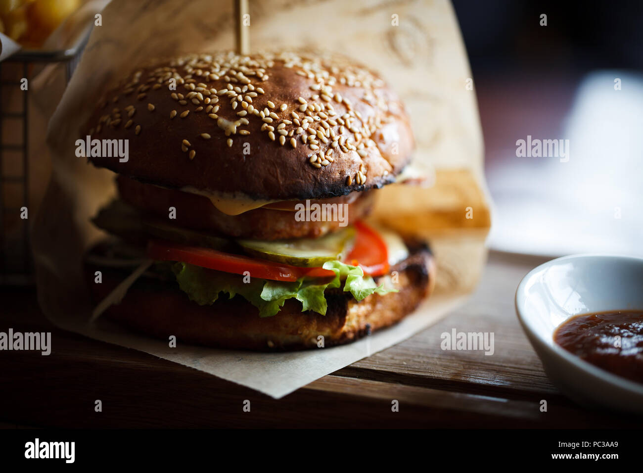 Delicious Hamburger With Big Tasty Meat Cutlet And Fresh Vegetables Served In Brown Paper On