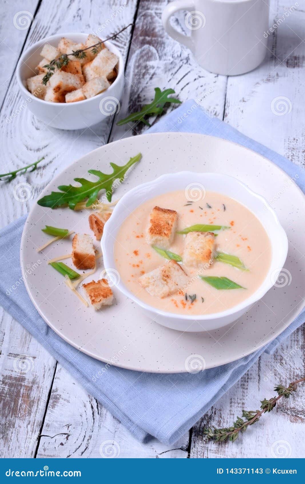 French Onion Soup In A White Bowl With Croutons And Cheese On Top