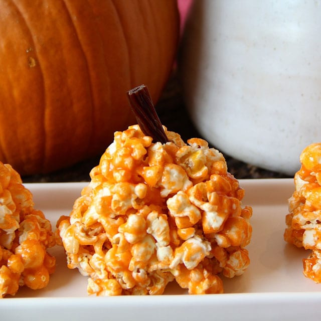 Hands Pulling Apart A Gooey Popcorn Ball Pumpkin Cookie Recipe