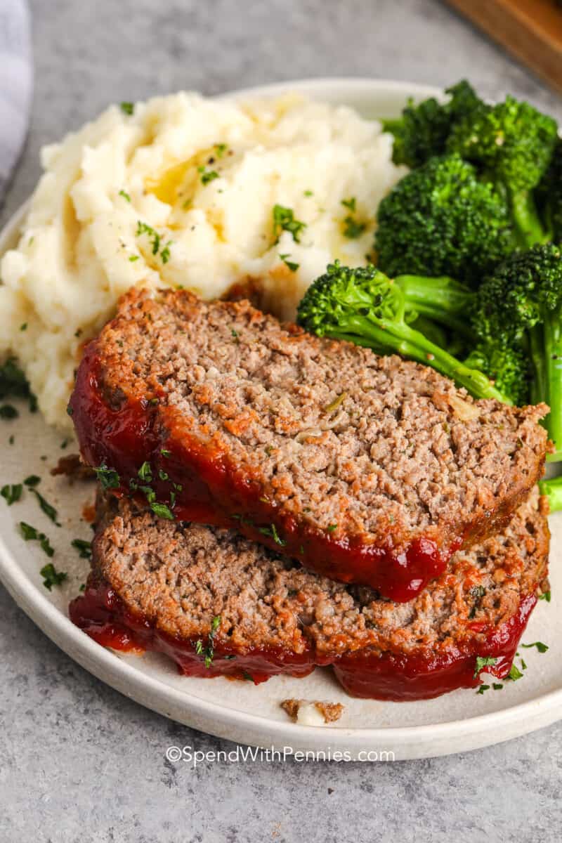 Meatloaf On A Plate With Sauce And Vegetables