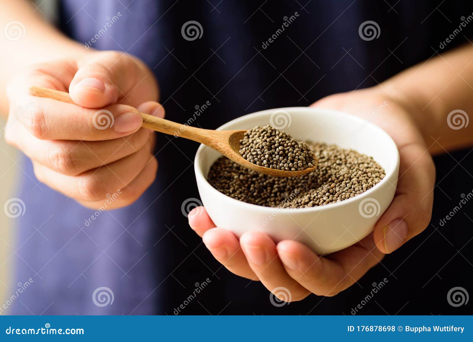 Perilla Seeds In A Wooden Bowl With Spoon Holding By Hand And Perilla